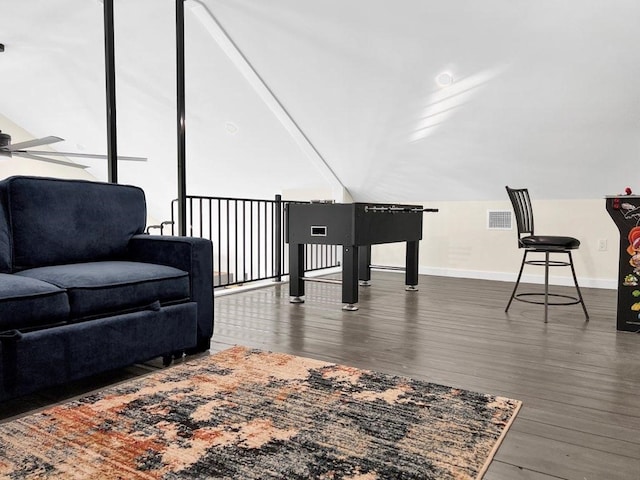 sitting room featuring lofted ceiling and dark wood-type flooring