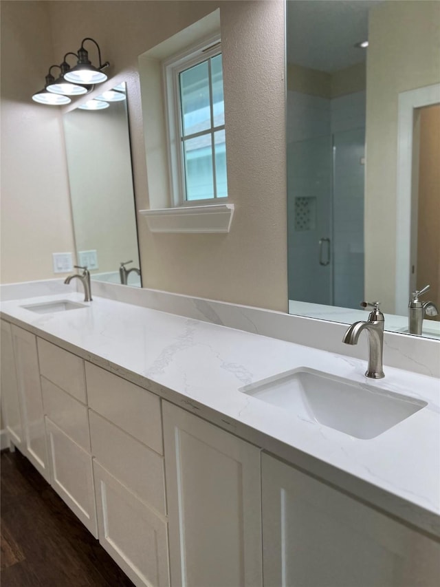 bathroom with vanity, hardwood / wood-style flooring, and walk in shower