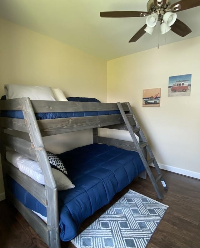 bedroom with dark hardwood / wood-style flooring and ceiling fan