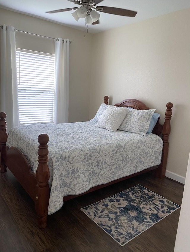 bedroom with dark wood-type flooring and ceiling fan