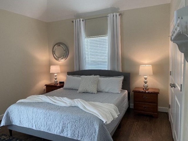 bedroom with dark hardwood / wood-style floors