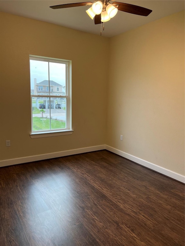 spare room featuring dark hardwood / wood-style floors and ceiling fan