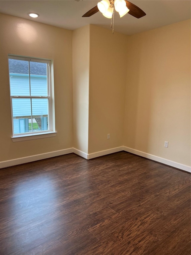 unfurnished room with dark hardwood / wood-style floors and ceiling fan