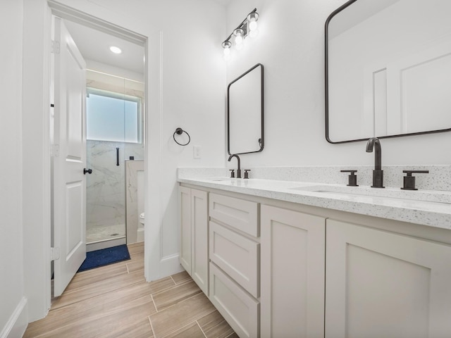 bathroom featuring vanity, an enclosed shower, and toilet