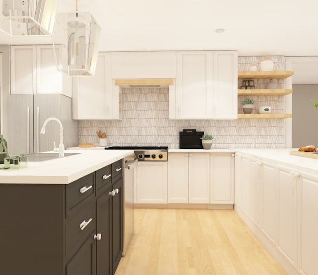 kitchen featuring stainless steel gas cooktop, light countertops, and white cabinetry