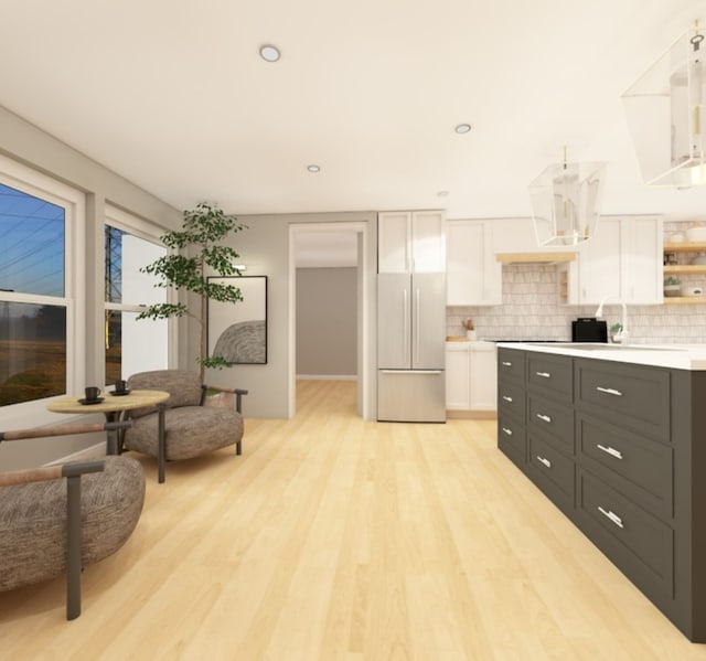 kitchen featuring white cabinets, refrigerator, light countertops, dark cabinetry, and open shelves