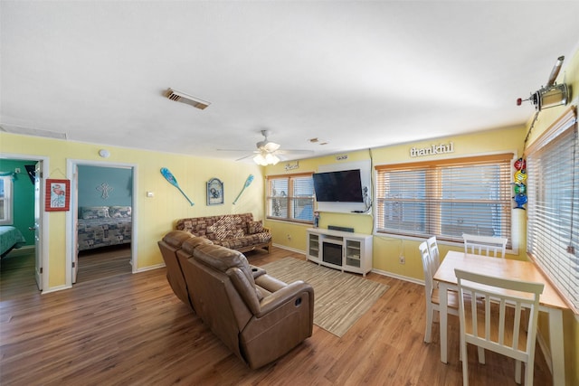 living room with ceiling fan and hardwood / wood-style floors