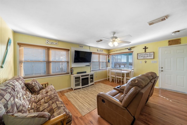 living room with hardwood / wood-style flooring and ceiling fan