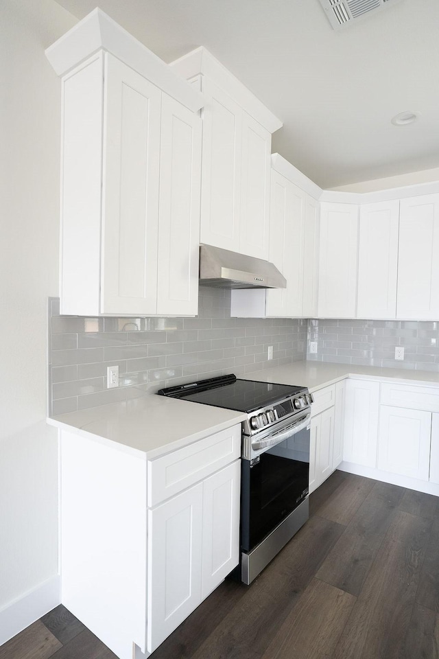 kitchen featuring electric stove, white cabinetry, dark hardwood / wood-style flooring, and tasteful backsplash