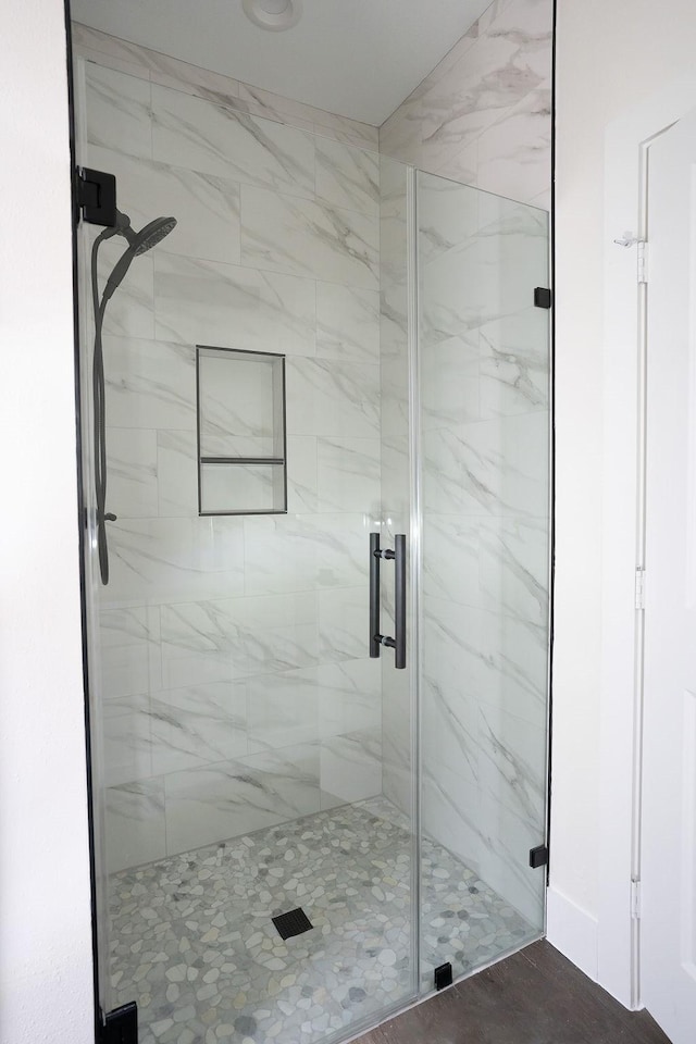 bathroom featuring a shower with shower door