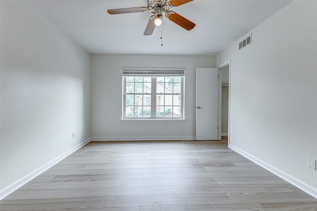 empty room featuring ceiling fan and light hardwood / wood-style flooring