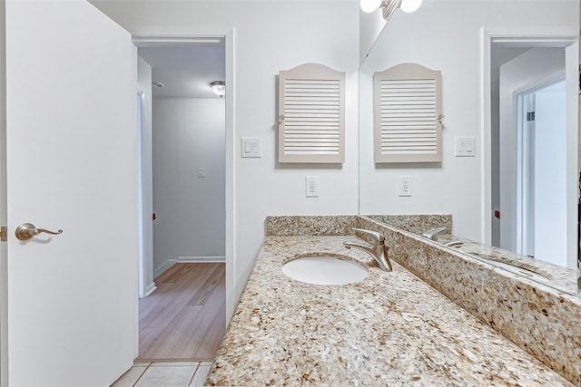 bathroom featuring vanity and wood-type flooring