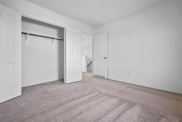 unfurnished bedroom featuring carpet floors and a closet