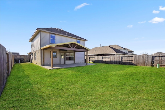 back of property with a yard and a patio area