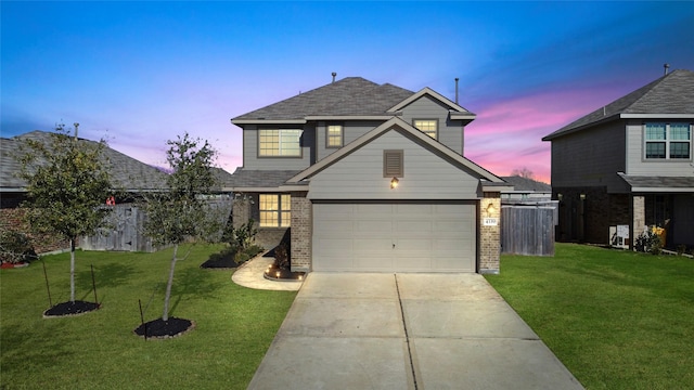 front of property with a yard and a garage