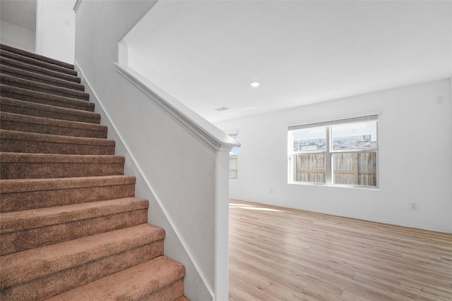 staircase with hardwood / wood-style flooring