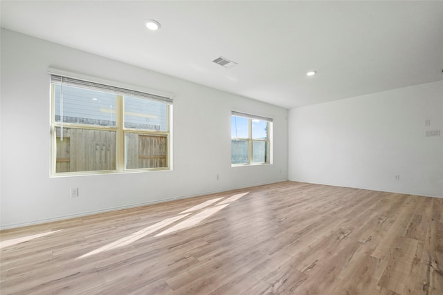 spare room with light hardwood / wood-style floors