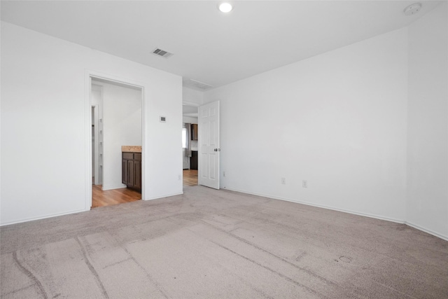 empty room with light colored carpet