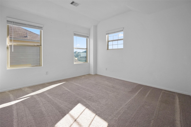 empty room featuring lofted ceiling and carpet floors