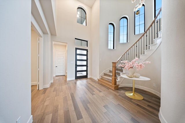 entrance foyer featuring light hardwood / wood-style floors and a high ceiling