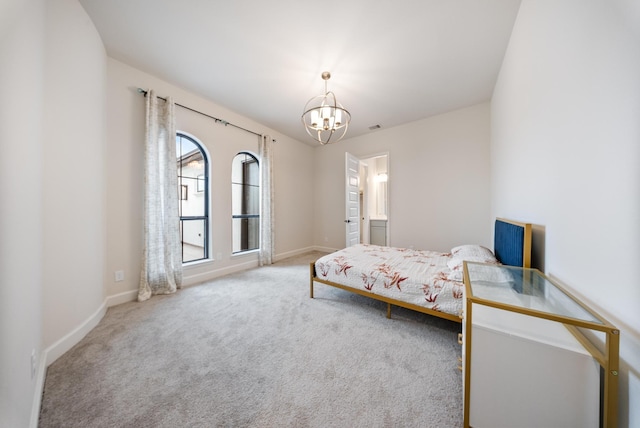 bedroom featuring carpet flooring and a chandelier