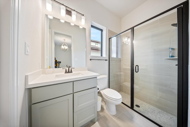 bathroom with vanity, tile patterned floors, toilet, and walk in shower