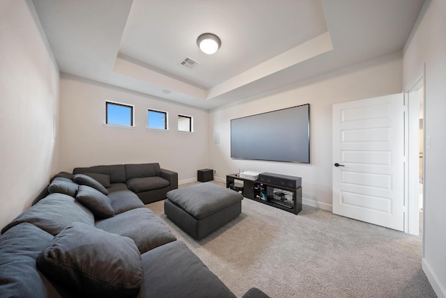 living room with light colored carpet and a raised ceiling