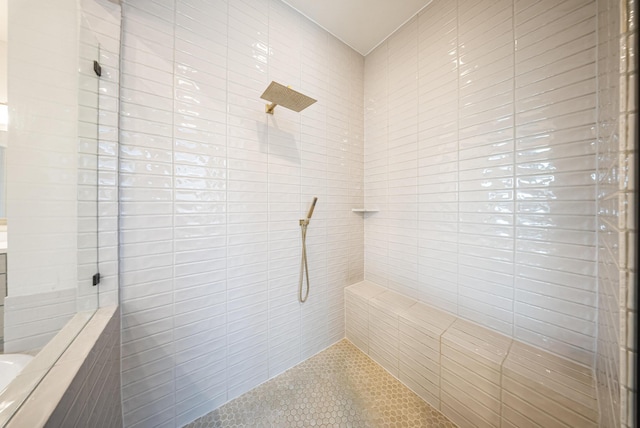 bathroom with tiled shower