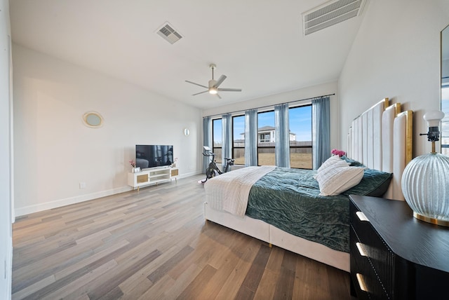 bedroom featuring ceiling fan, lofted ceiling, and light hardwood / wood-style floors