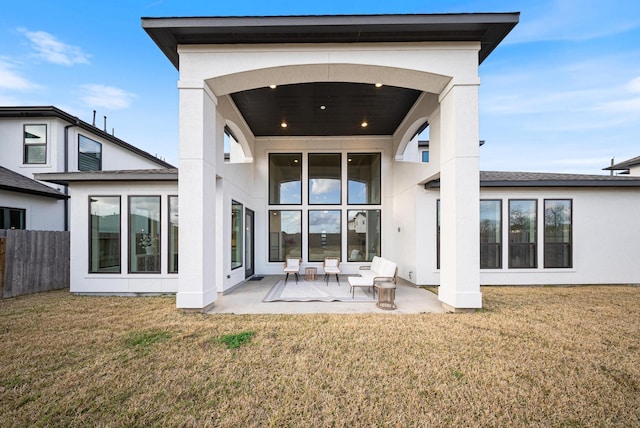 rear view of house featuring a yard and a patio area