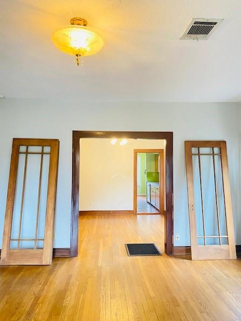 spare room featuring light hardwood / wood-style flooring