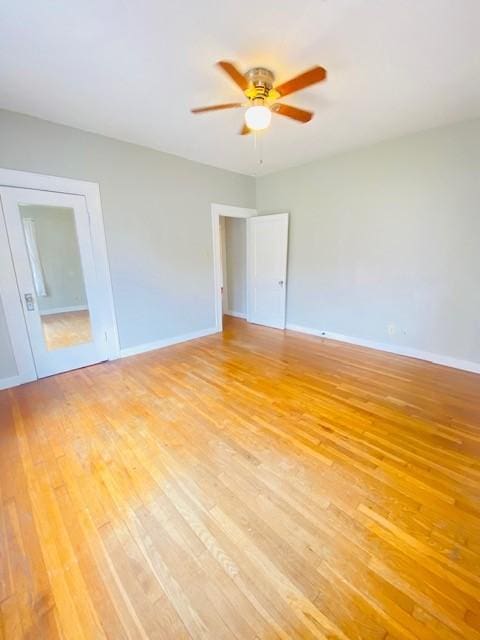 spare room featuring ceiling fan and light hardwood / wood-style floors