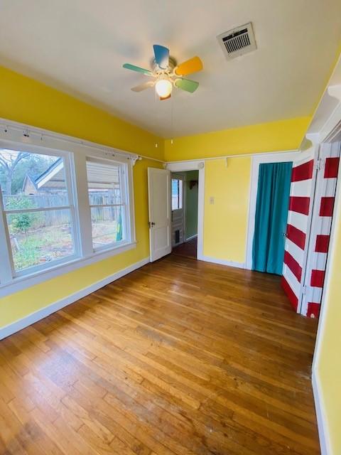 interior space with hardwood / wood-style floors and ceiling fan