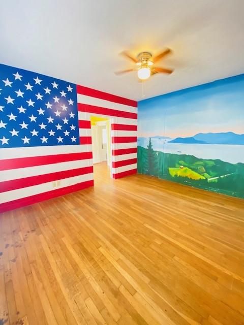 interior space with hardwood / wood-style flooring and ceiling fan