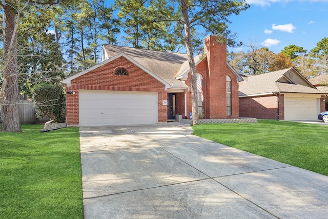 view of front of property with a garage and a front lawn