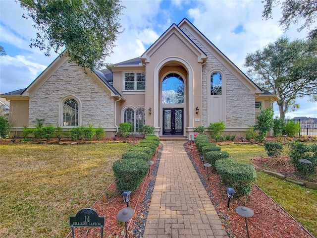 view of front of property with french doors and a front yard