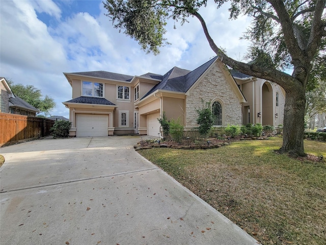 view of front of home with a garage and a front lawn