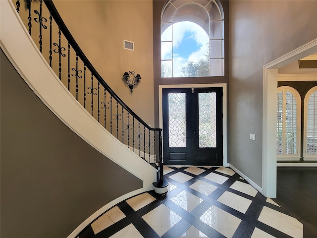 entrance foyer featuring french doors and a high ceiling