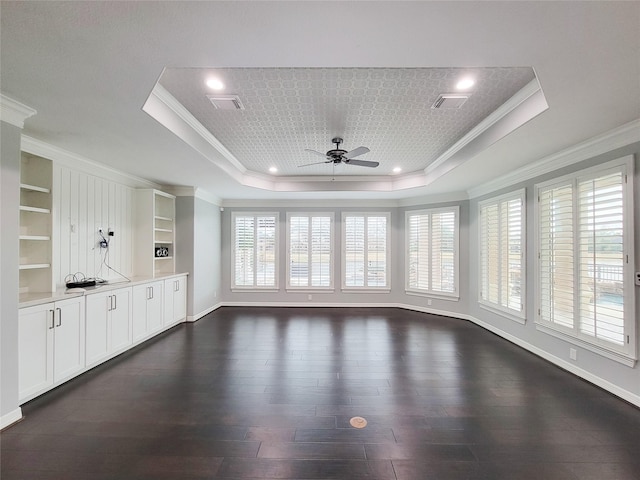 interior space with crown molding, dark hardwood / wood-style floors, and a raised ceiling