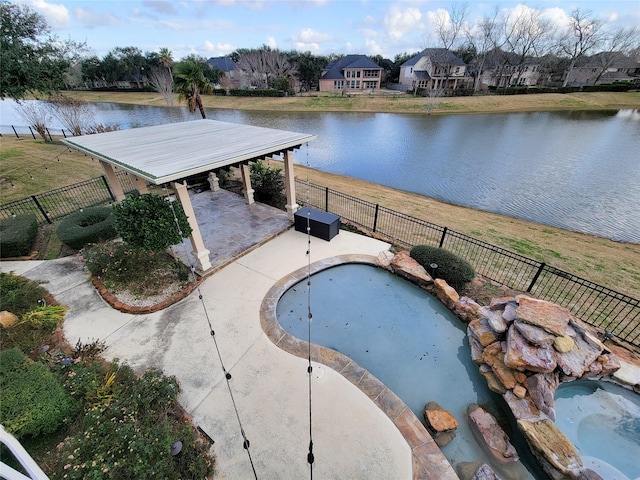 view of pool with a water view and a patio area