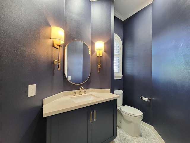 bathroom featuring crown molding, vanity, and toilet