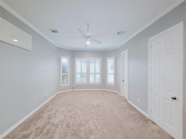 carpeted spare room featuring ornamental molding and ceiling fan