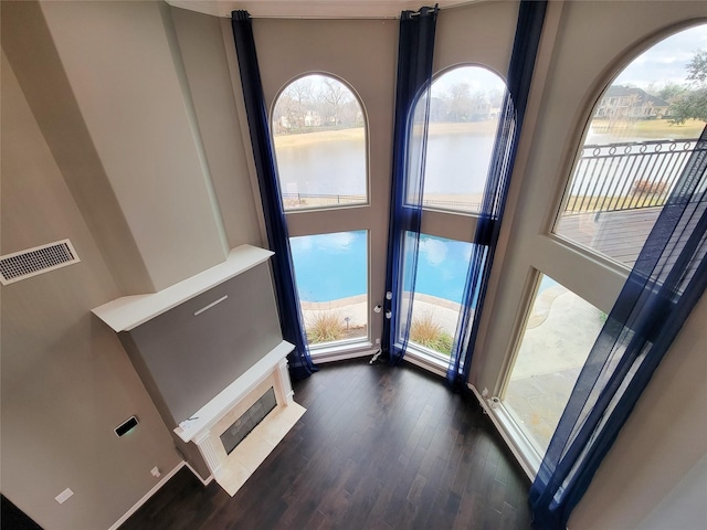 room details featuring hardwood / wood-style flooring and a water view