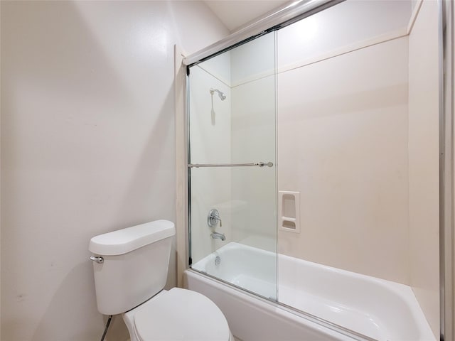 bathroom featuring enclosed tub / shower combo and toilet