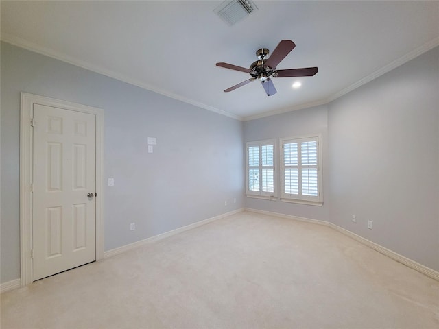 carpeted empty room with crown molding and ceiling fan