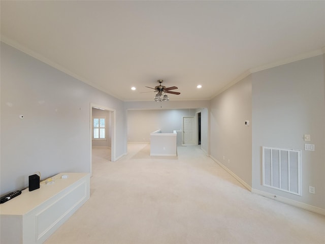 empty room featuring light carpet, crown molding, and ceiling fan