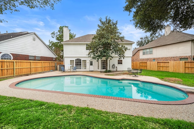 view of swimming pool with a patio, a yard, a fenced backyard, and a fenced in pool