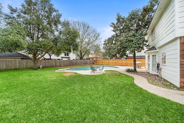 view of yard featuring a patio area, a fenced backyard, and a fenced in pool