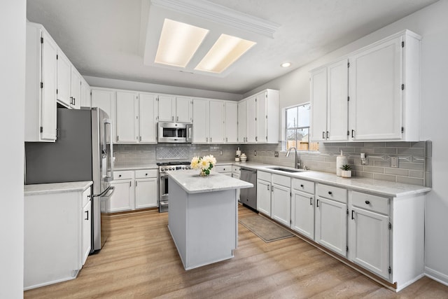 kitchen featuring appliances with stainless steel finishes, a center island, and white cabinets