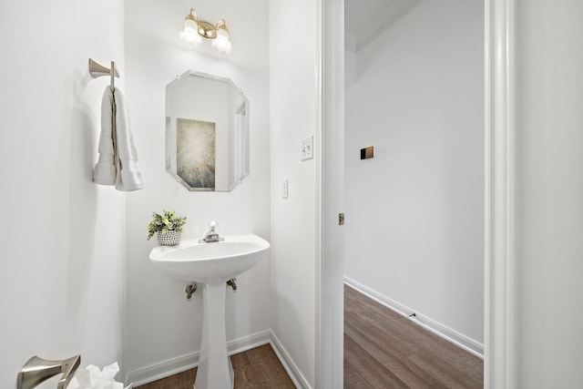 bathroom with wood finished floors and baseboards